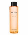 Inuka tissue oil bottle with orange liquid on a white background